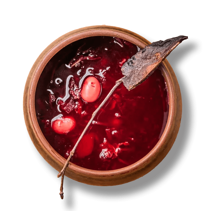 Bowl of traditional Ukrainian borshch with meat, garnished and served in a restaurant setting