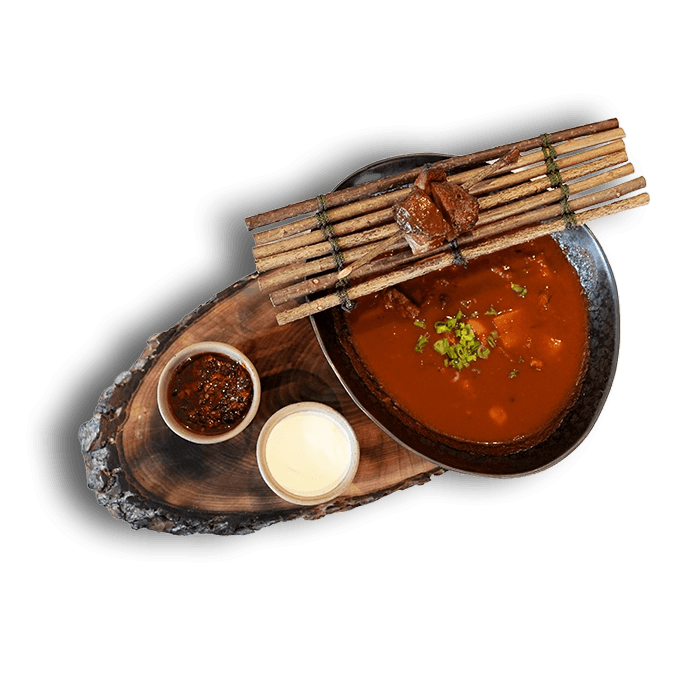 Transcarpathian bogrács goulash with meat and vegetables in a clay pot